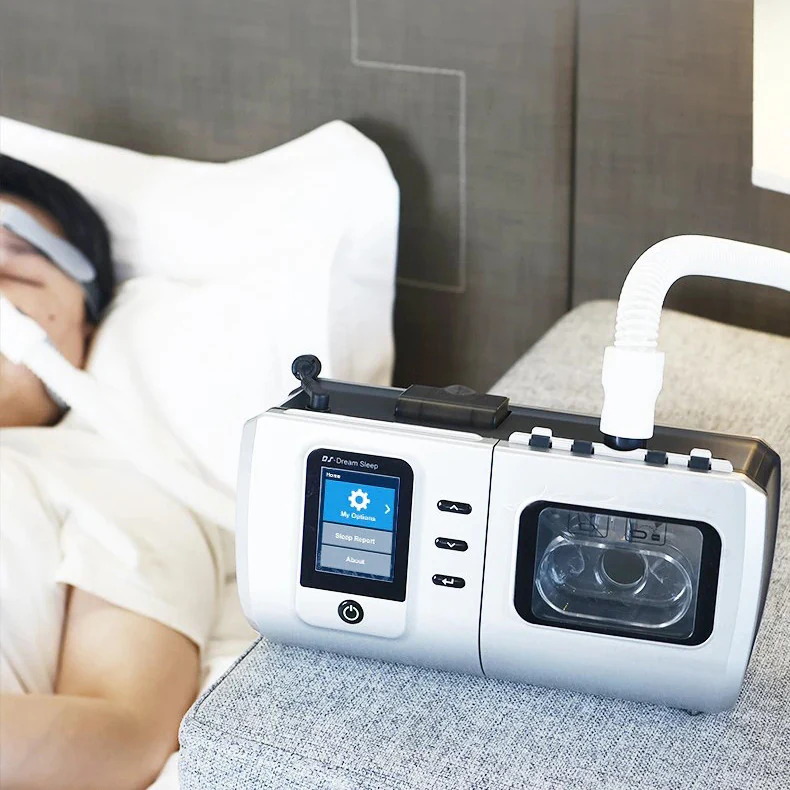 CPAP machine set up beside a bed for nighttime use